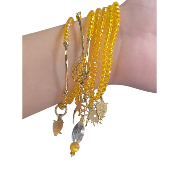 Rubylishious
Handmade yellow glass bead bracelet with gold charms
Set of 7 bra - Picture 2 of 2